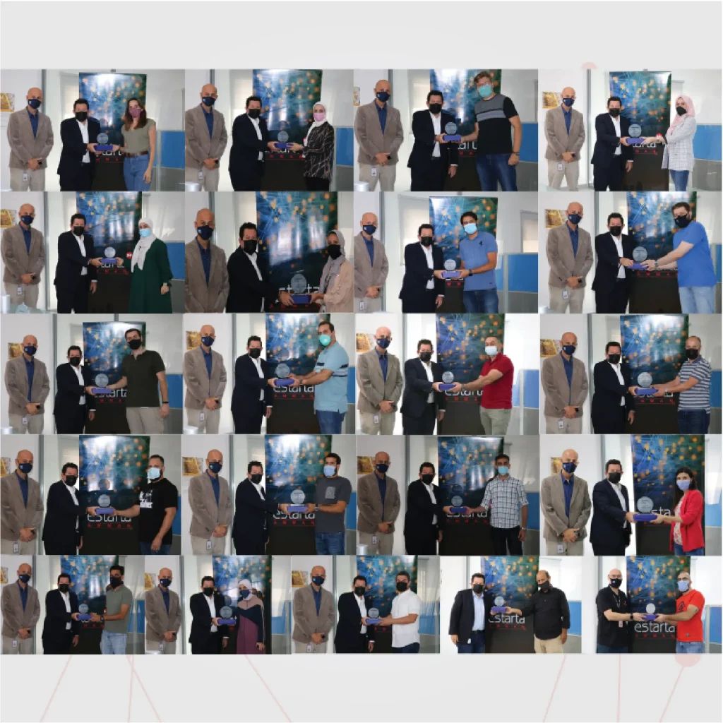 A collage of multiple images shows long-tenured employees wearing masks and formal attire receiving awards and certificates from others. The background features a banner with colorful designs. Recipients and presenters from Estarta celebrate, shaking hands and holding their certificates proudly.